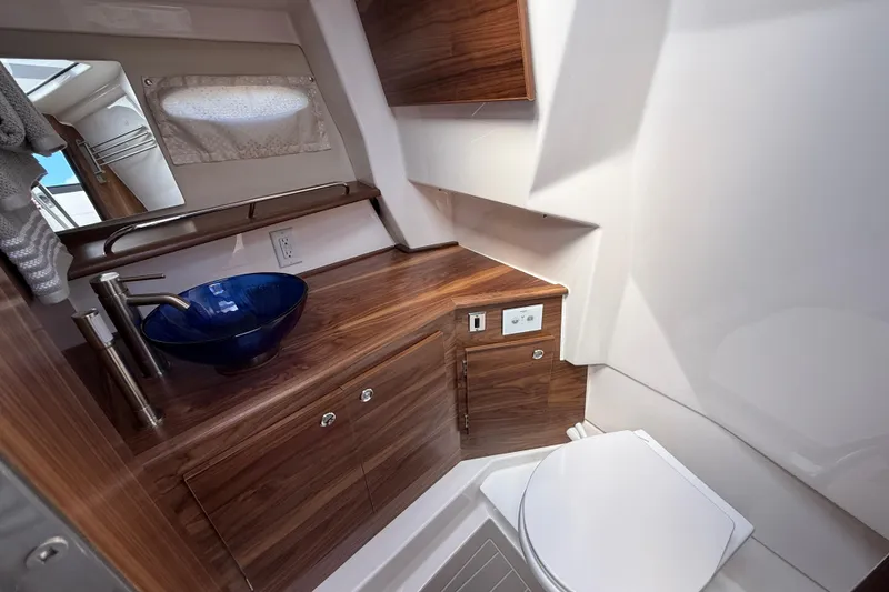 Slide: The Image of Luxurious bathroom in 2026 Solara S-310 SB yacht with modern fixtures and wood accents. - 22