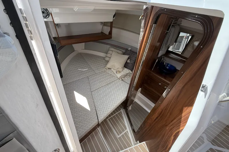 Slide: The Image of Interior of 2026 Solara S-310 SB boat with cozy cabin and wooden accents. - 23