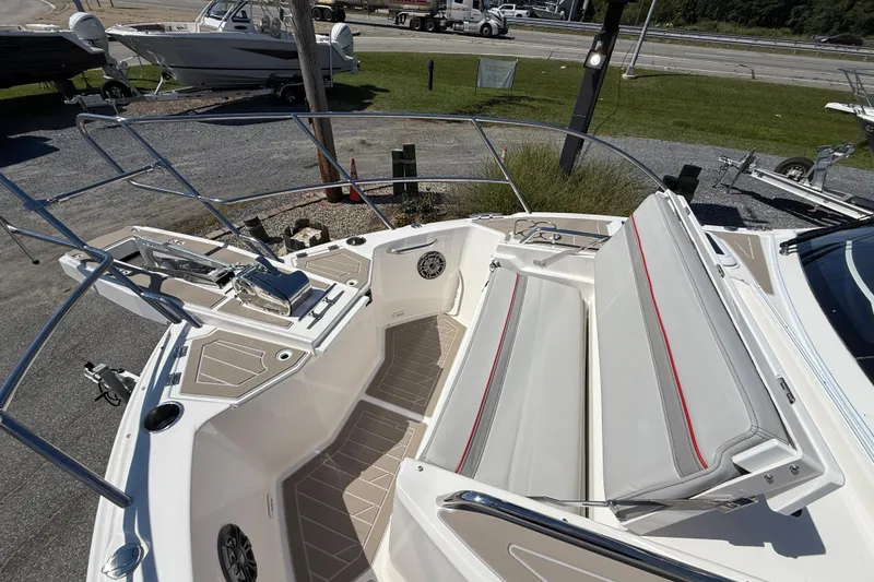 Slide: The Image of 2026 Solara S-310 SB boat interior with cushioned seating and deck details. - 24