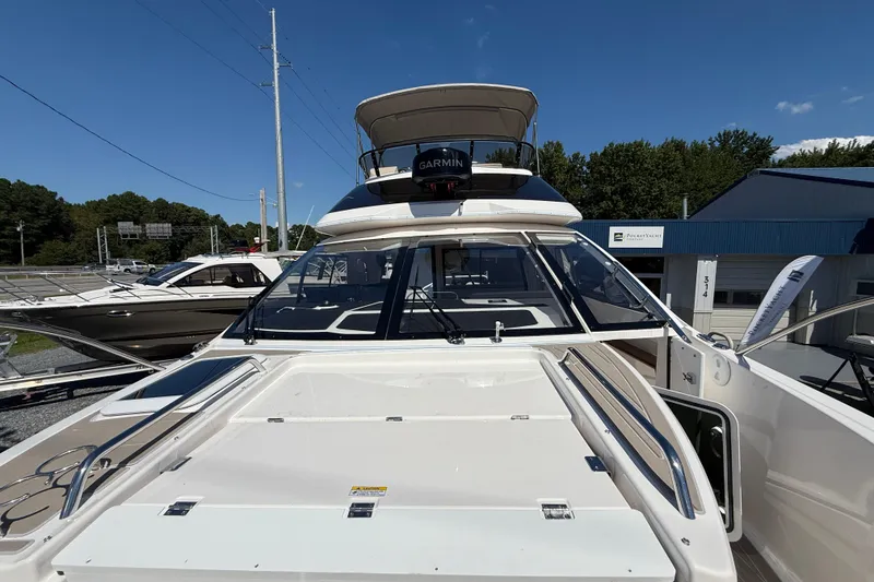 Slide: The Image of 2026 Solara S-310 SB yacht with sleek design, docked outdoors under clear blue sky. - 25