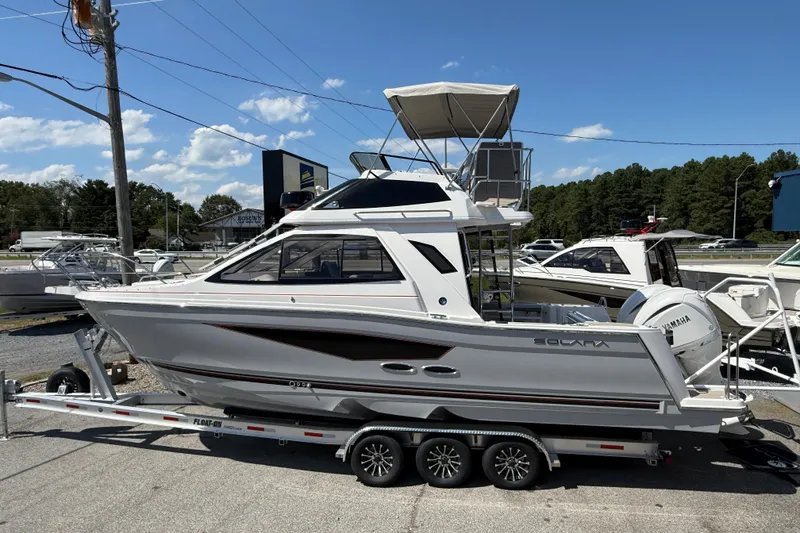 Slide: The Image of 2026 Solara S-310 SB boat on trailer, parked outdoors under clear blue sky. - 3