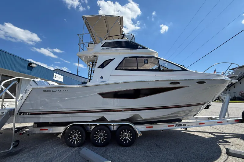Slide: The Image of 2026 Solara S-310 SB boat on trailer under clear blue sky. - 7