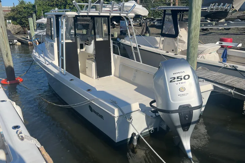 The Image of 2022 May-Craft 2300 Pilot House boat with Honda 250 VTEC engine docked in marina. - 0