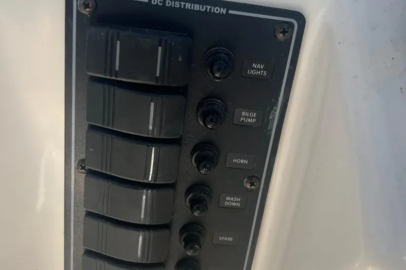 Slide: The Image of Control panel of a 2022 May-Craft 2300 Pilot House boat with labeled switches. - 11