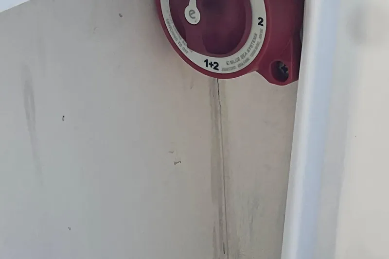 Slide: The Image of Red battery switch on 2022 May-Craft 2300 Pilot House boat interior. - 12