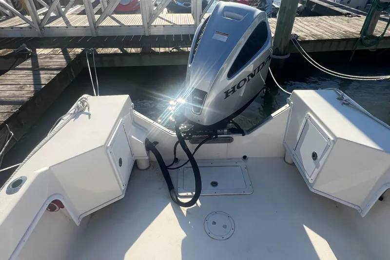 Slide: The Image of 2022 May-Craft 2300 Pilot House boat with Honda outboard motor at dock. - 3