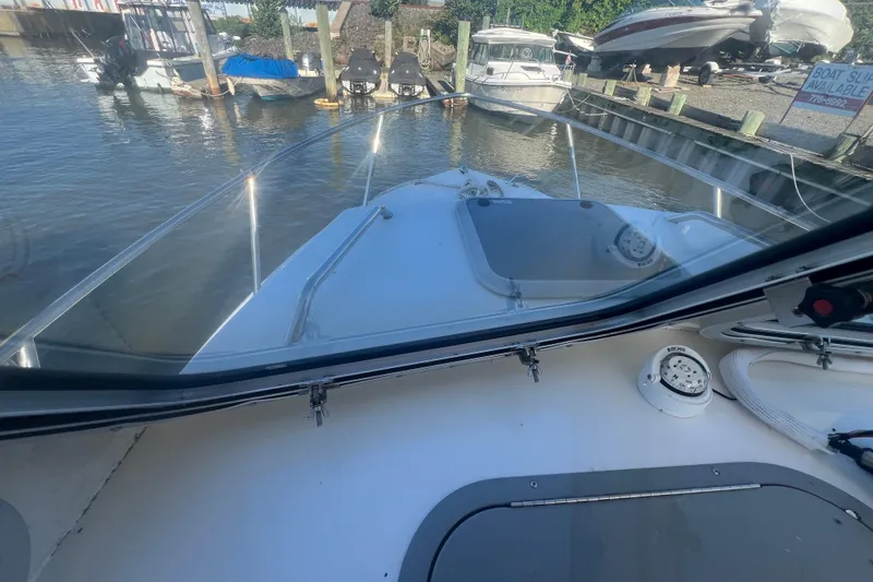 Slide: The Image of 2022 May-Craft 2300 Pilot House boat docked at marina, viewed from cabin. - 7