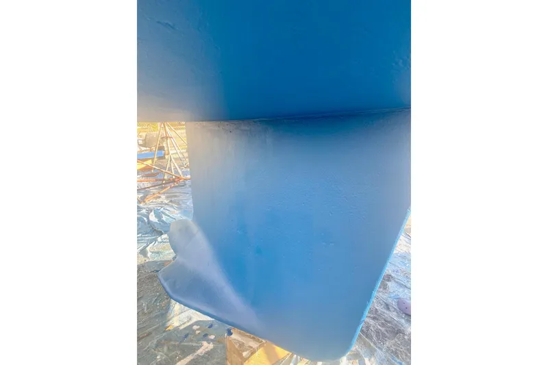 Slide: The Image of Blue hull of a 1997 Beneteau Oceanis 461 sailboat, showing keel detail. - 16