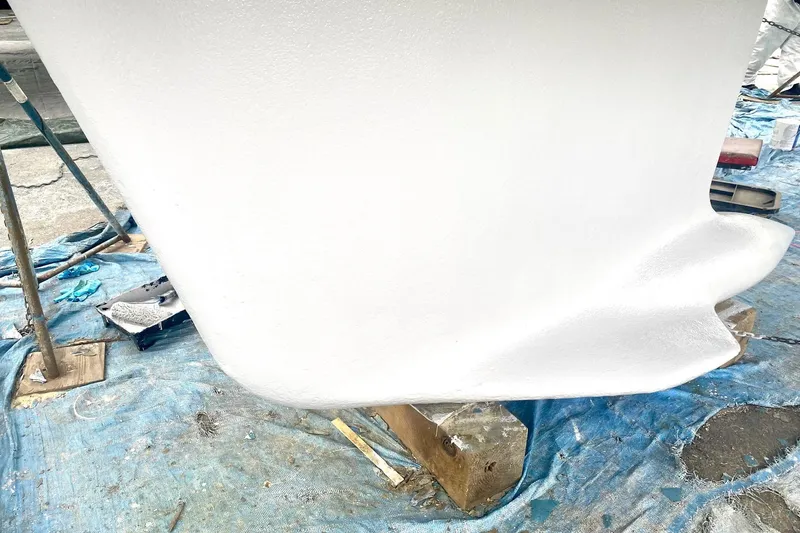 Slide: The Image of Freshly painted keel of a 1997 Beneteau Oceanis 461 sailboat on a tarp. - 17
