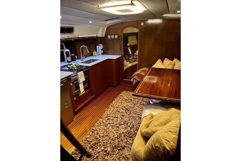 Slide: The Image of Interior of 1997 Beneteau Oceanis 461 yacht with cozy kitchen and seating area. - 20