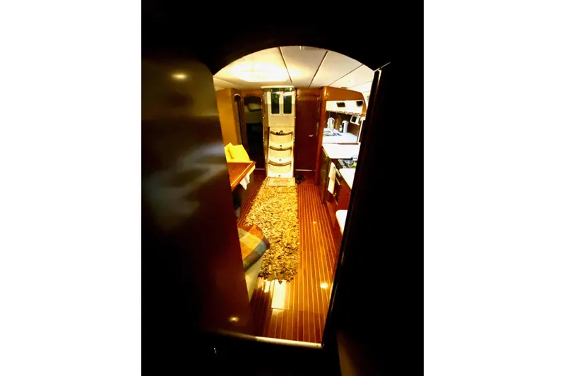 Slide: The Image of Interior view of 1997 Beneteau Oceanis 461 yacht, featuring elegant wood finishes and cozy seating. - 25