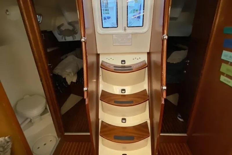 Slide: The Image of Interior of 1997 Beneteau Oceanis 461 sailboat with wooden steps and cabin view. - 32