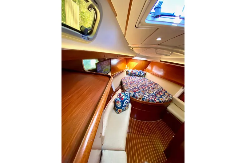 Slide: The Image of Cozy cabin interior of 1997 Beneteau Oceanis 461 with colorful bedding and wood finish. - 36