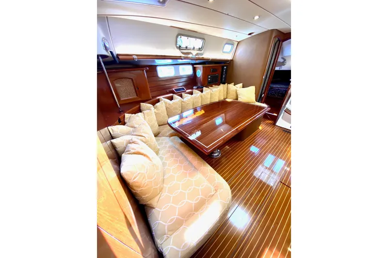 Slide: The Image of Luxurious interior of 1997 Beneteau Oceanis 461 yacht with polished wood and plush seating. - 40
