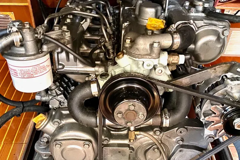 Slide: The Image of Engine of a 1997 Beneteau Oceanis 461 sailboat, showcasing mechanical components and belts. - 42