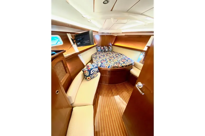Slide: The Image of Luxurious cabin interior of 1997 Beneteau Oceanis 461 sailboat with wood finish and cozy bedding. - 46