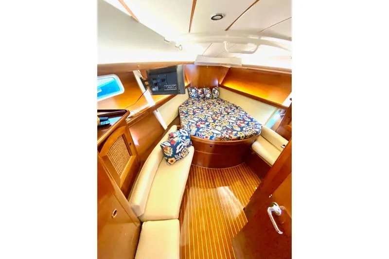 Slide: The Image of Cozy cabin interior of 1997 Beneteau Oceanis 461 sailboat with patterned bedding and wooden finish. - 48