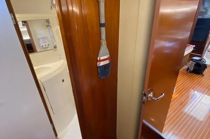 Slide: The Image of Interior of 1997 Beneteau Oceanis 461 yacht showing bathroom and wooden cabin details. - 49