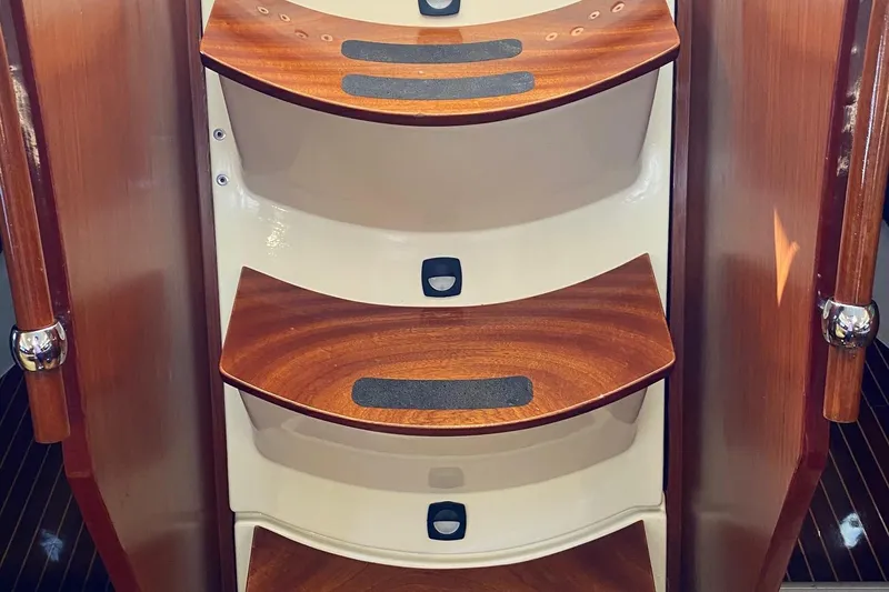 Slide: The Image of Wooden steps inside a 1997 Beneteau Oceanis 461 yacht, featuring sleek design and grip strips. - 51