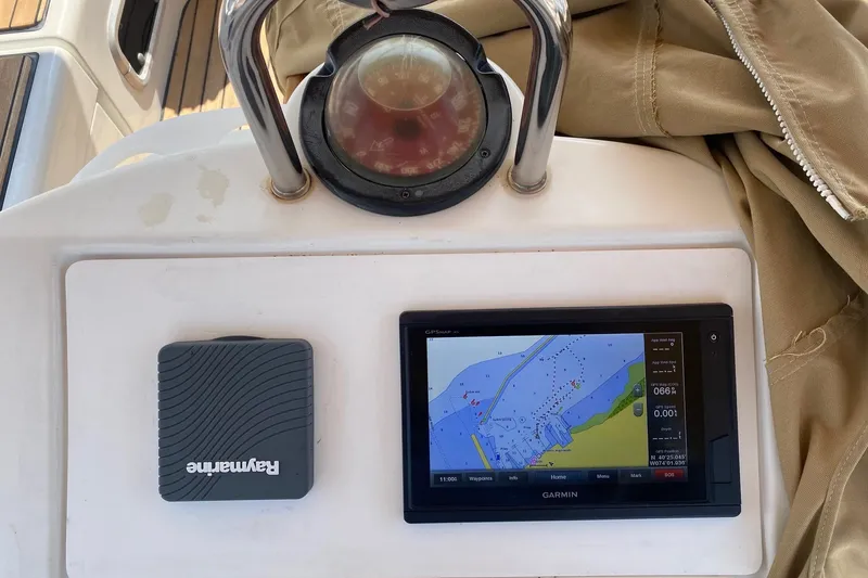 Slide: The Image of Navigation equipment on 1997 Beneteau Oceanis 461 sailboat, featuring Garmin and Raymarine devices. - 59