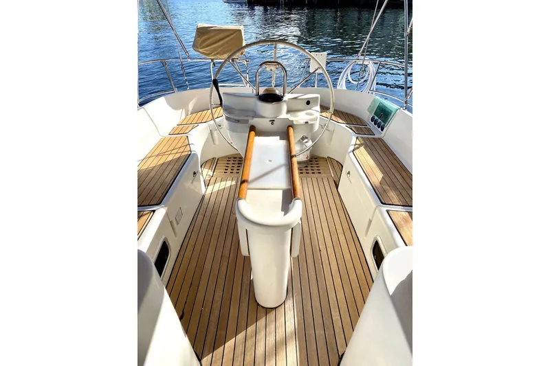Slide: The Image of Cockpit of 1997 Beneteau Oceanis 461 sailboat with wooden deck and steering wheel. - 6