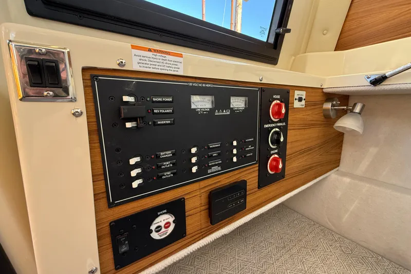 Slide: The Image of Control panel of 2026 Ranger Tugs R-23 boat, featuring switches and gauges. - 16