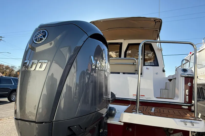 Slide: The Image of 2026 Ranger Tugs R-23 boat with Yamaha 200 outboard motor, docked under clear sky. - 3