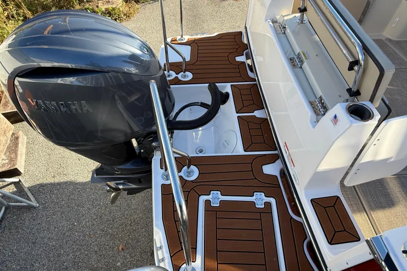 Slide: The Image of 2026 Ranger Tugs R-23 boat with Yamaha outboard motor and teak-style deck. - 4