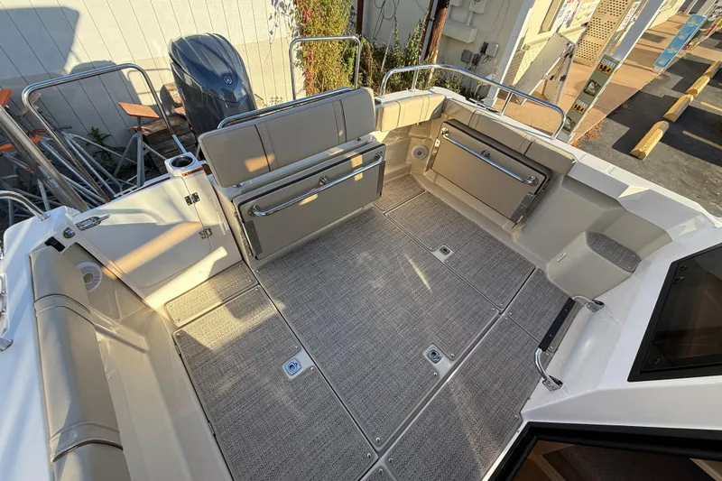 Slide: The Image of 2026 Ranger Tugs R-23 boat interior with foldable seating and spacious deck area. - 5