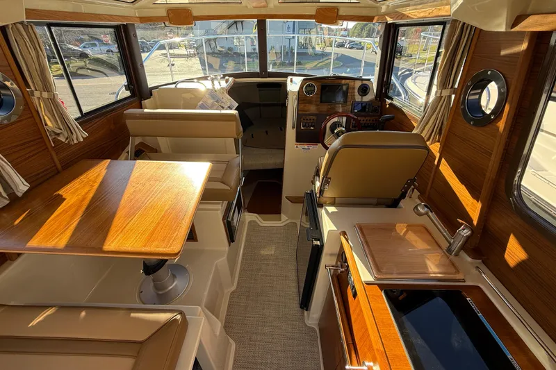 Slide: The Image of Interior of 2026 Ranger Tugs R-23 boat, featuring wood finishes and modern amenities. - 8