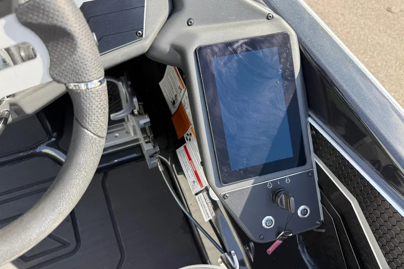 Slide: The Image of 2026 Skeeter FXR21 FLEX dashboard with touchscreen and steering wheel detail. - 10