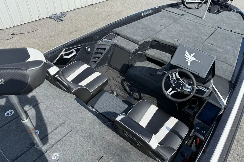 Slide: The Image of 2026 Skeeter FXR21 FLEX boat interior with modern seating and steering console. - 15