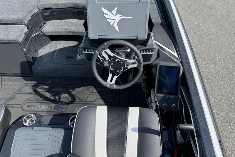 Slide: The Image of 2026 Skeeter FXR21 FLEX boat cockpit with steering wheel and digital display. - 16
