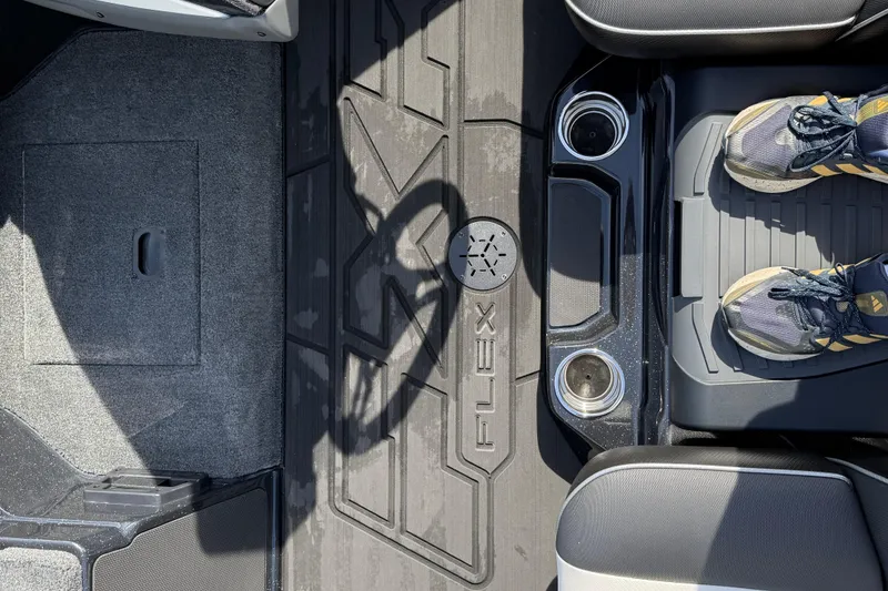 Slide: The Image of 2026 Skeeter FXR21 FLEX boat interior with textured flooring and cup holders. - 17