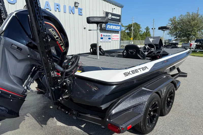 Slide: The Image of 2026 Skeeter FXR21 FLEX boat with powerful engine, parked outside marine dealership. - 19