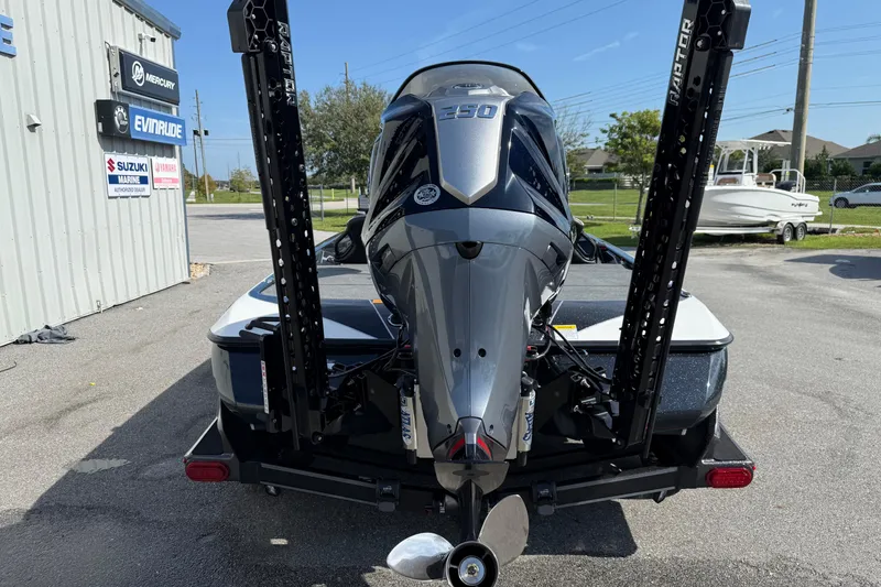 Slide: The Image of 2026 Skeeter FXR21 FLEX boat with powerful outboard motor in a marina setting. - 21