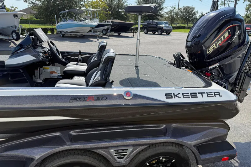 Slide: The Image of 2026 Skeeter FXR21 FLEX boat with Yamaha SHO engine, parked outdoors. - 5