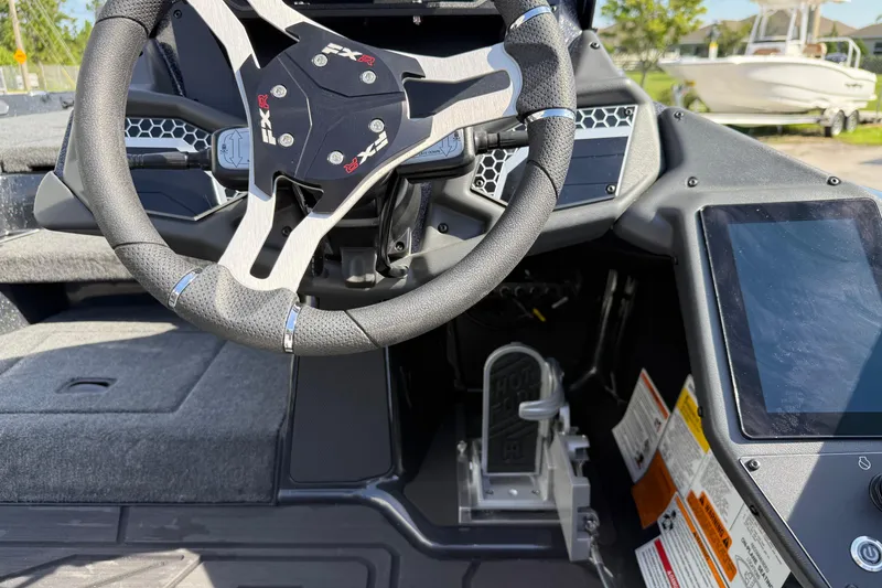 Slide: The Image of 2026 Skeeter FXR21 FLEX boat cockpit with steering wheel and digital controls. - 8