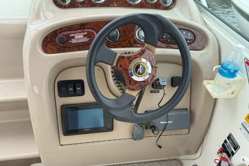 Slide: The Image of Steering console of a 2003 Sea Ray 260 Sundancer boat with navigation equipment. - 12