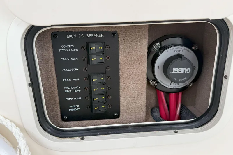Slide: The Image of Main DC breaker panel on 2003 Sea Ray 260 Sundancer boat, featuring various switches and controls. - 15