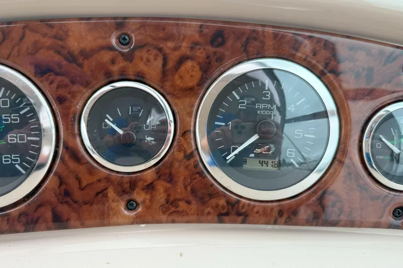 Slide: The Image of Dashboard of a 2003 Sea Ray 260 Sundancer boat with RPM and trim gauges. - 16