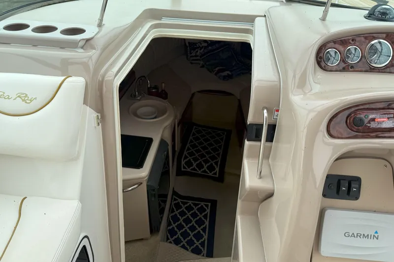 Slide: The Image of 2003 Sea Ray 260 Sundancer cabin interior with dashboard and seating area. - 18