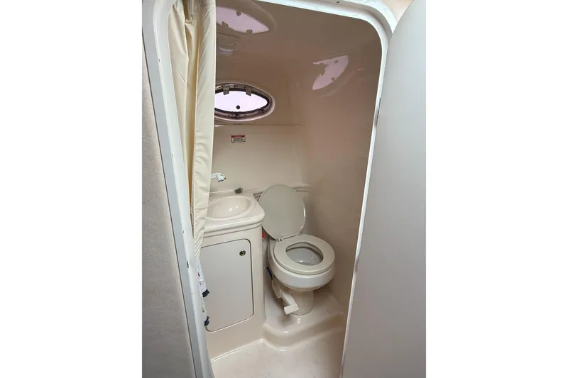 Slide: The Image of Compact bathroom in 2003 Sea Ray 260 Sundancer boat with toilet and sink. - 22