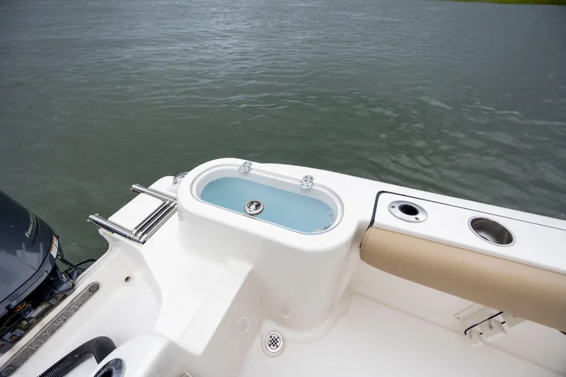 Slide: The Image of 2017 Key West 244 Center Console boat with livewell and seating, on calm water. - 13