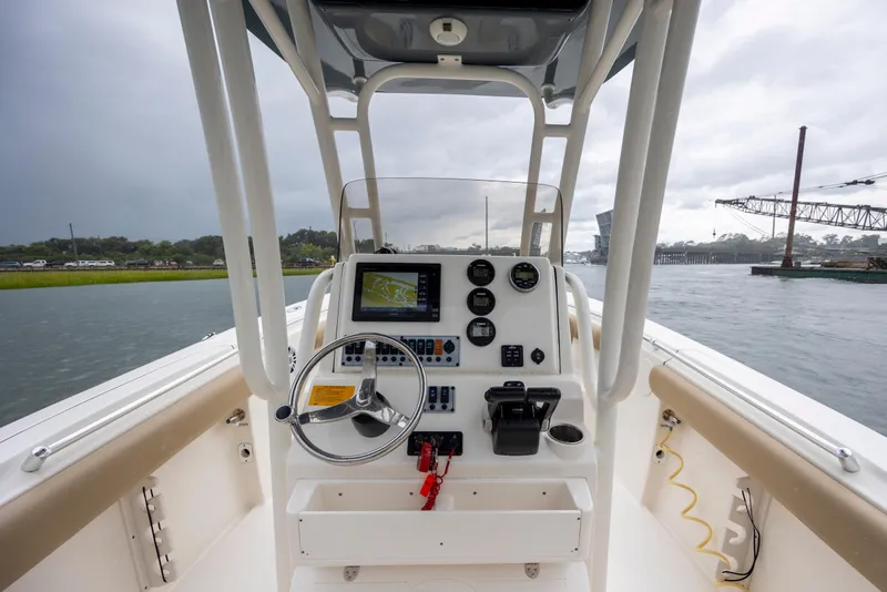 Slide: The Image of 2017 Key West 244 Center Console boat dashboard with steering wheel and navigation system. - 14