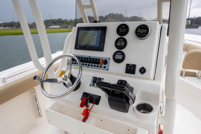 Slide: The Image of 2017 Key West 244 Center Console boat dashboard with steering wheel and navigation instruments. - 16