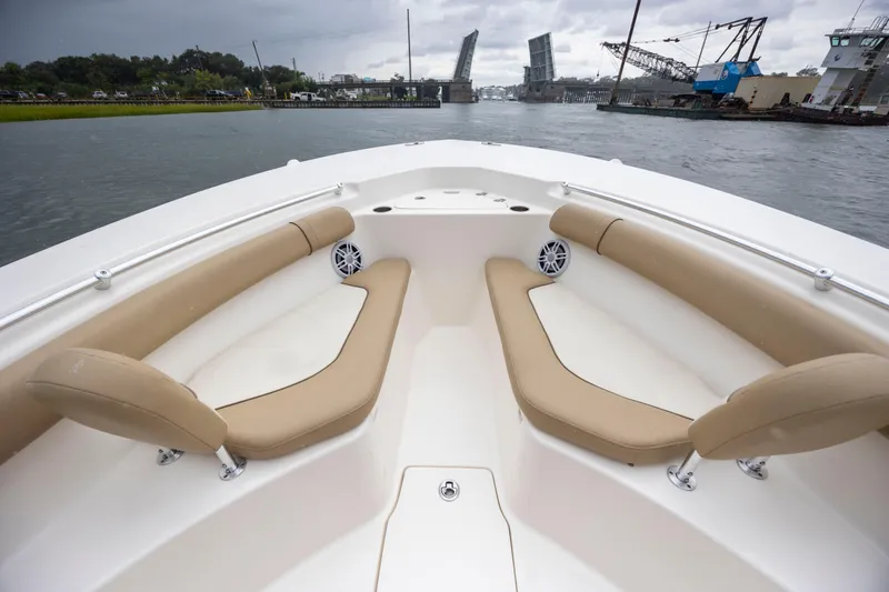 Slide: The Image of 2017 Key West 244 Center Console boat interior with tan seating, open water, and drawbridge view. - 18