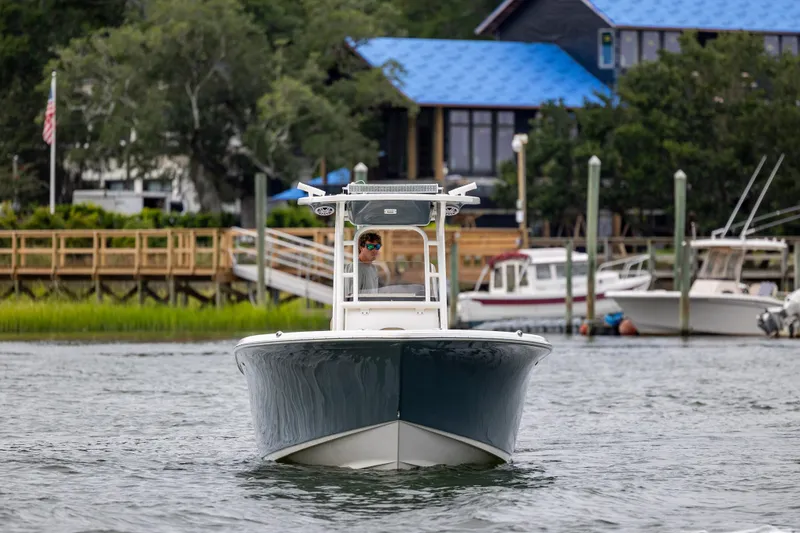 Slide: The Image of 2017 Key West 244 Center Console boat on water near dock and buildings. - 4