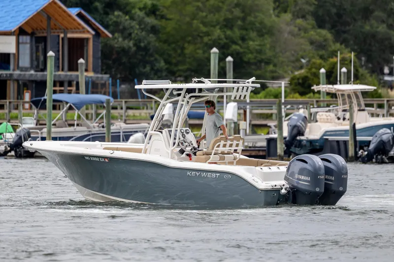 Slide: The Image of 2017 Key West 244 Center Console boat with dual Yamaha engines on a calm waterway. - 9