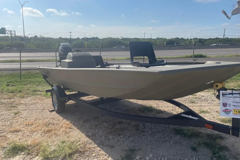 The Image of 2026 Tracker Grizzly 1754 SC boat on trailer, parked outdoors under clear sky. - 0